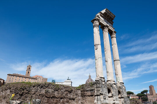 The ancient columns of the Temple of Castor and Pollux with the Capitoline Hill in the background at Forum Romanum in Rome, Italy