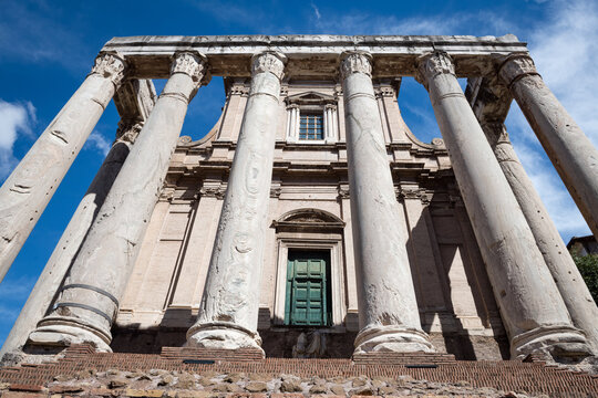 Symmetrical low angle view of the grand staircase and columns of the Temple of Antoninus and Faustina in Forum Romanum, Rome, Italy