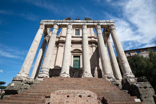 Symmetrical low angle view of the grand staircase and columns of the Temple of Antoninus and Faustina in Forum Romanum, Rome, Italy
