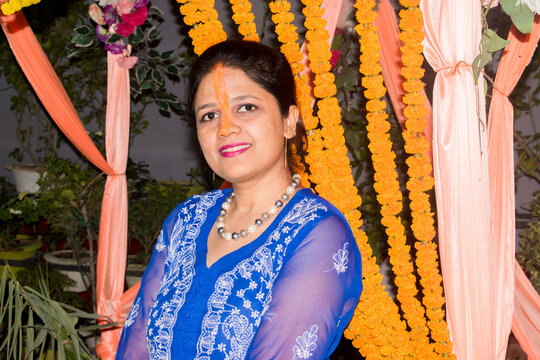 Bihari married lady with vibrant orange sindoor extending from the forehead hairline, symbolizing marital tradition and cultural heritage.