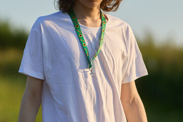 Fototapeta premium Person wearing hidden disability sunflower lanyard