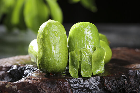 Fresh Peeled Kiwi Fruit Slices with Water Droplets on Wooden Surface - Vitamin Rich Tropical Fruit