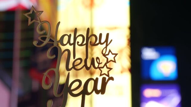 Happy New Year text sign on Times Square in New York City, United States. Illuminated screens during Christmas holidays in December on Manhattan. Festive celebration on Broadway in USA. Glowing lights