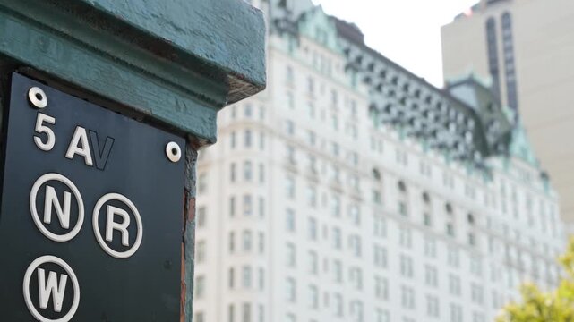 New York City street, subway entrance sign on 5 fifth avenue near Central Park, United States. American underground transportation, Manhattan Midtown transport. Station near Grand Army Plaza and hotel
