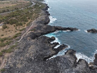 Drone view of the corniche road above the volcanic coast of L'Etang-Sale, Reunion © Mathis