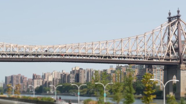 New York City Manhattan Midtown, Queensboro bridge architecture in United States. Urban transport bridge. Metallic bridge over East River esplanade in East Side. Urban park near Roosevelt island.