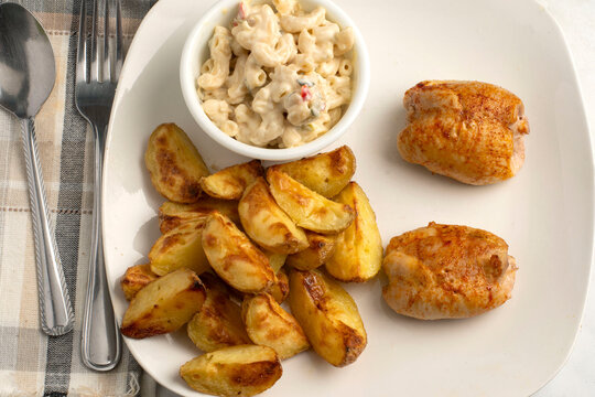 chicken thighs  with  a side of potato wedges