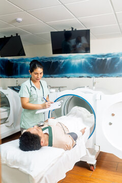 Healthcare professional preparing patient for hyperbaric oxygen therapy