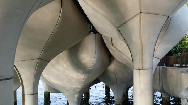 New York City Little Island pier park in Midtown of Manhattan, United States. Urban architecture on pillars in Chelsea, USA. Futuristic contemporary design, river water reflections on concrete columns