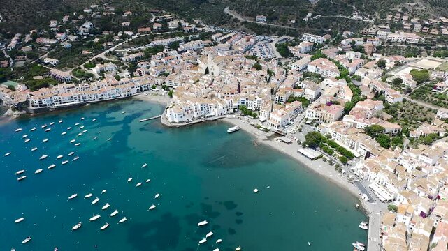 Aerial view of the picturesque fishing village of Cadaqu&eacute;s, featuring its whitewashed houses, historic waterfront, peaceful harbor and the crystal-clear waters of the Mediterranean on the Costa Brava.