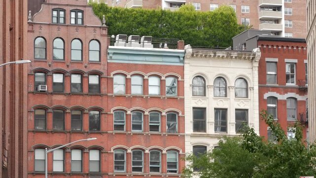 New York City urban residential buildings architecture, Lower Manhattan historic classic street, United States of America. Typical old red brick house in NYC, real estate property in USA. Windows.