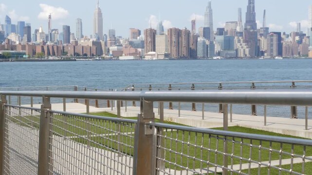 Manhattan Midtown skyline, Edge Park ferry pier promenade, North Williamsburg, New York City USA. East River waterfront, Brooklyn. Financial district skyscrapers architecture. Riverfront cityscape.