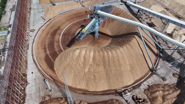 Circular stockyard with stacker reclaimer operating on sand and gravel storage site
