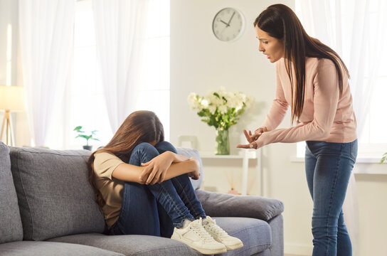 Angry strict mother lecturing her naughty daughter, yelling and scolding small girl for doing something wrong, have conflict and misunderstanding, bad relationships. Generation gap concept