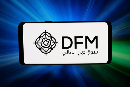 Stuttgart, Germany - 06-22-2026: In this photo illustration, the logo of stock exchange Dubai Financial Market (DFM) is displayed on a smartphone in front of abstract background on computer screen.
