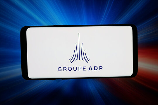 Stuttgart, Germany - 06-22-2026: In this photo illustration, the logo of French airport operator company Groupe ADP is displayed on a smartphone in front of abstract background on computer screen.