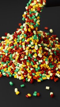 Black polypropylene plastic granules pouring from a cup onto a resin pellet pile on black background, 3D render dynamic Vertical video.
