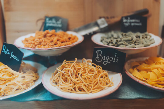 Delicious pasta displayed in a charming Italian market with various shapes and colors inviting everyone to enjoy fresh flavors