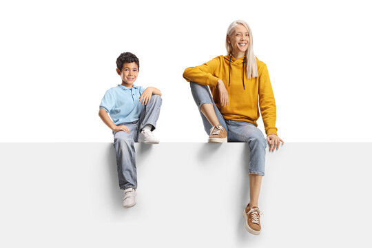 Little boy and a woman sitting on a white panel