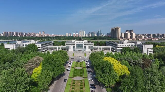 Modern government building complex in Rizhao city overlooking the river under clear blue sky