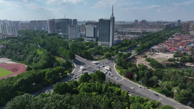 Rizhao city main road surrounded by green trees with modern high-rise buildings
