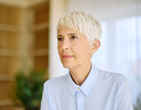 Portrait of an active senior elderly businesswoman during a meeting in the office