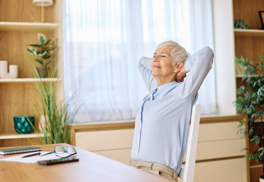 Portrait of a mature senior  businesswoman resting after a meeting in the office