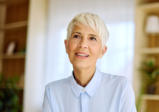 Portrait of an active senior elderly businesswoman during a meeting in the office