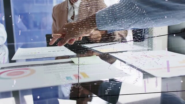 Presenter reaching and pointing chart on glass table in business meeting, overlay tracing gestures