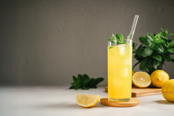 Fototapeta premium Chilled lemonade with mint and ice in tall glass, refreshing summer beverage concept, copy space
