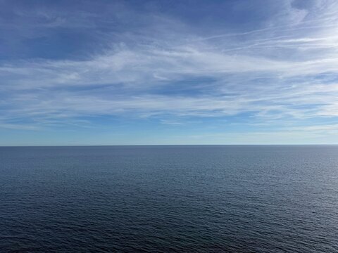 Open sea and blue sky with clouds.
