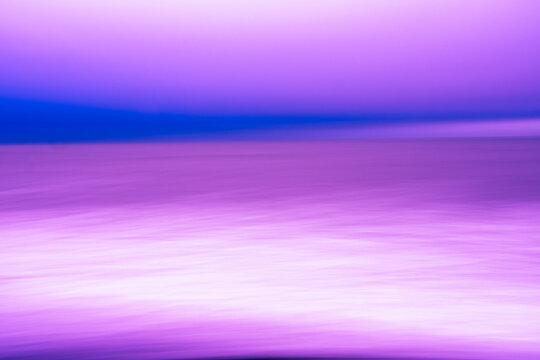 Colourful blurred coastal background in purple and blue