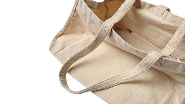 Blank tote bag template made of light beige canvas fabric isolated on transparent background cut out