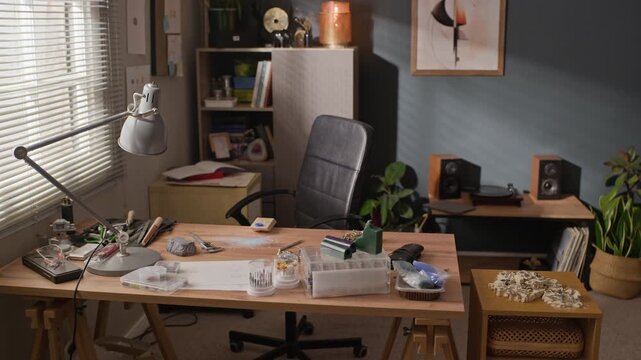 No people shot of empty creative jewelry workshop desk sitting ready for craft production. Clip ideal for small business marketing, handmade craft promotions, and creative entrepreneurship videos