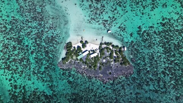 Aerial drone flying over bora bora turquoise lagoon and motu