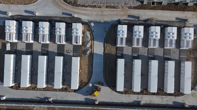 Aerial view of battery energy storage station with containerized battery arrays arranged in rows