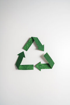 Green recycling symbol isolated on white background, sustainability and environmental conservation concept