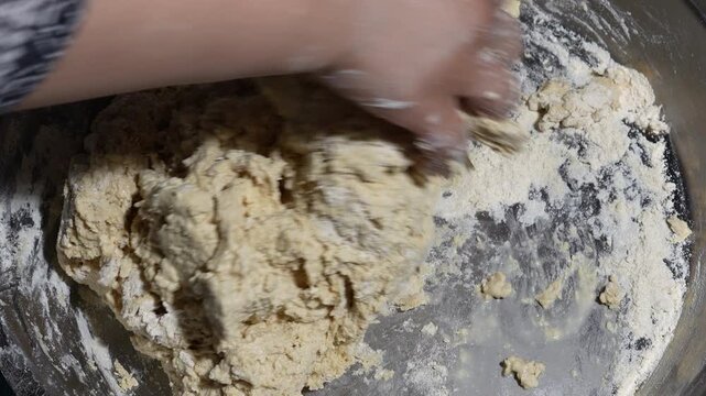 Baker mixing wheat flour and water to make pastry dough