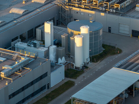 Aerial view of a cryogenic gas system with white storage tanks and industrial buildings at a facility in Piorunow, Masovian Voivodeship, Poland.