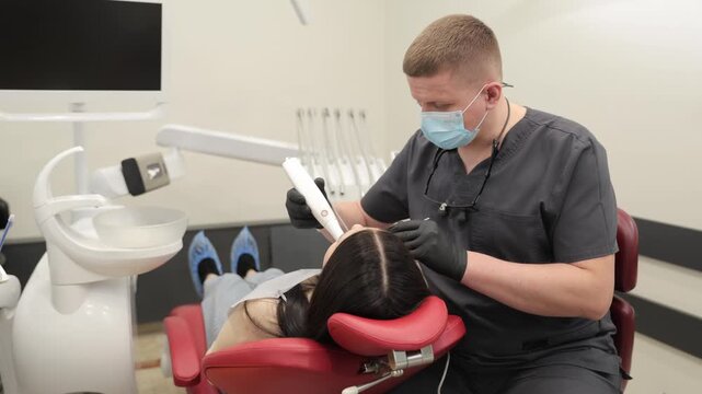 Dentist using an intraoral 3d scanner on patient