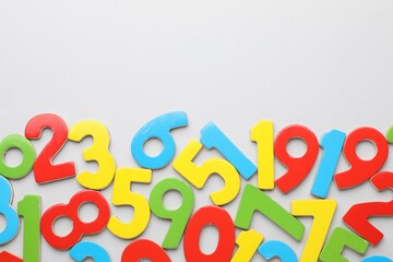 Fototapeta premium Many colorful numbers on grey background, flat lay. Space for text