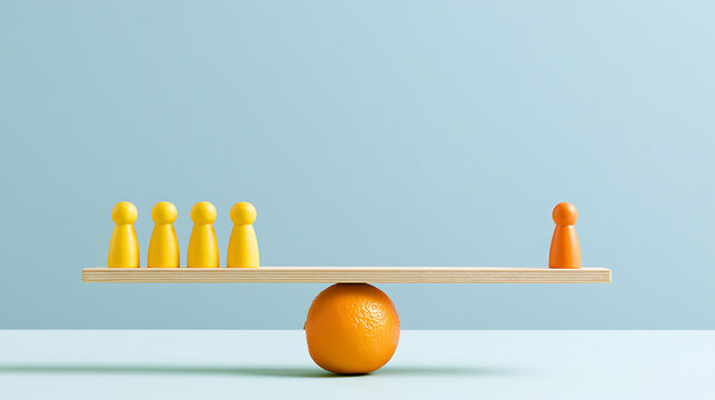 Conceptual image of yellow and orange game pieces on a wooden seesaw balanced by an orange, illustrating imbalance and comparison on a blue background