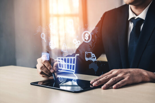 Businessman Using Tablet for Online Shopping with Shopping Cart Icon and Digital Symbols Representing E-commerce and Delivery Services. Entropy.