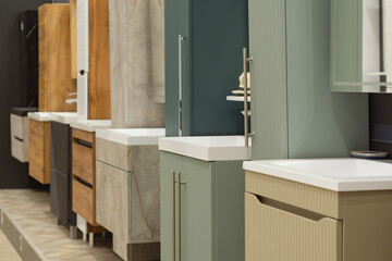 Obraz premium Modern bathroom vanity cabinets and washbasins displayed in a showroom interior. Contemporary bathroom furniture, interior design solutions, home renovation and sanitary ware for retail.