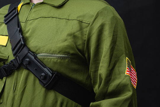 Security guard or law enforcement officer wearing tactical uniform with chest pouch and USA flag patch on dark background. Public safety, professional security services, patrol and emergency response.