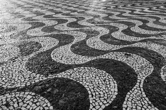 Mosaic portuguese pavement, black and white, wavelike. Pedestrian mall in downtown Manaus