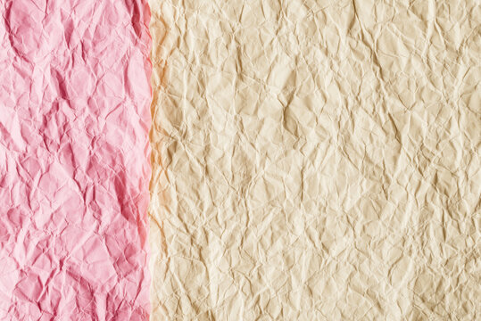 Beautiful full frame texture of crumpled paper in pink and beige pastel colors. Abstract wrinkled paper background banner representing zero waste, craft and minimalist design.