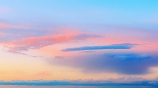 Vivid dusk sky background at sunset with calm twilight atmosphere. Beautiful pastel sky background banner visualizing peace, harmony, inspiration and tranquility.