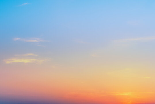 Beautiful sunset sky background with soft pastel pink and blue colors. Majestic sunrise sky texture banner with copy space representing freedom, hope and serenity.