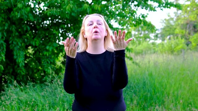 Overwhelmed by high temperatures woman fans herself with hands wipes sweat from forehead. scene illustrates heat exhaustion summer weather discomfort dehydration risk and seasonal challenges.